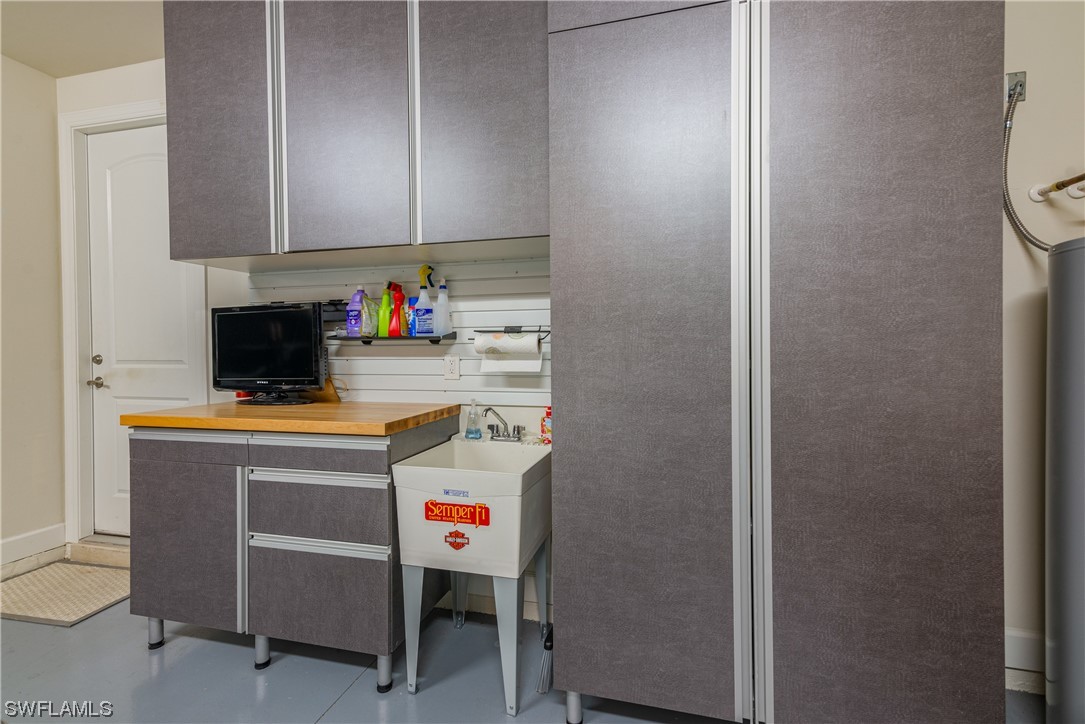 20198 Corkscrew Shores Boulevard Estero, FL 33928 - Photo 24 of 50 a kitchen with a refrigerator and cabinets