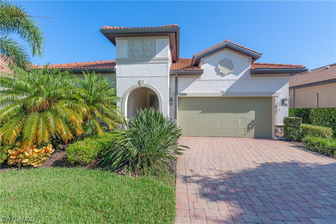 20198 Corkscrew Shores Boulevard Estero, FL 33928 - Photo 33 of 50 a front view of a house with a garden and plants