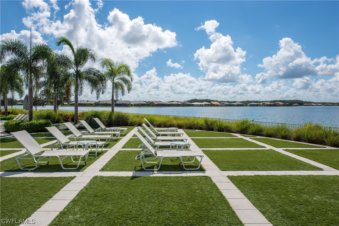 20198 Corkscrew Shores Boulevard Estero, FL 33928 - Photo 45 of 50 a view of a swimming pool with lounge chairs on th table