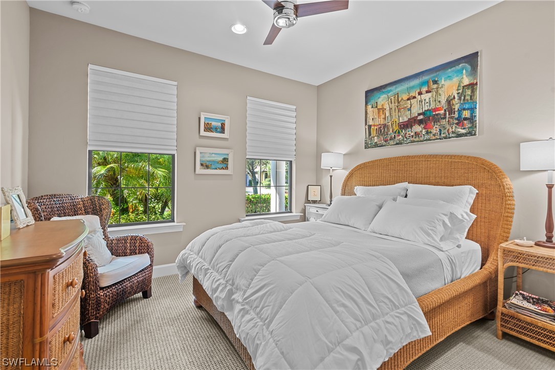 20198 Corkscrew Shores Boulevard Estero, FL 33928 - Photo 9 of 50 a bed sitting in a bedroom next to a window