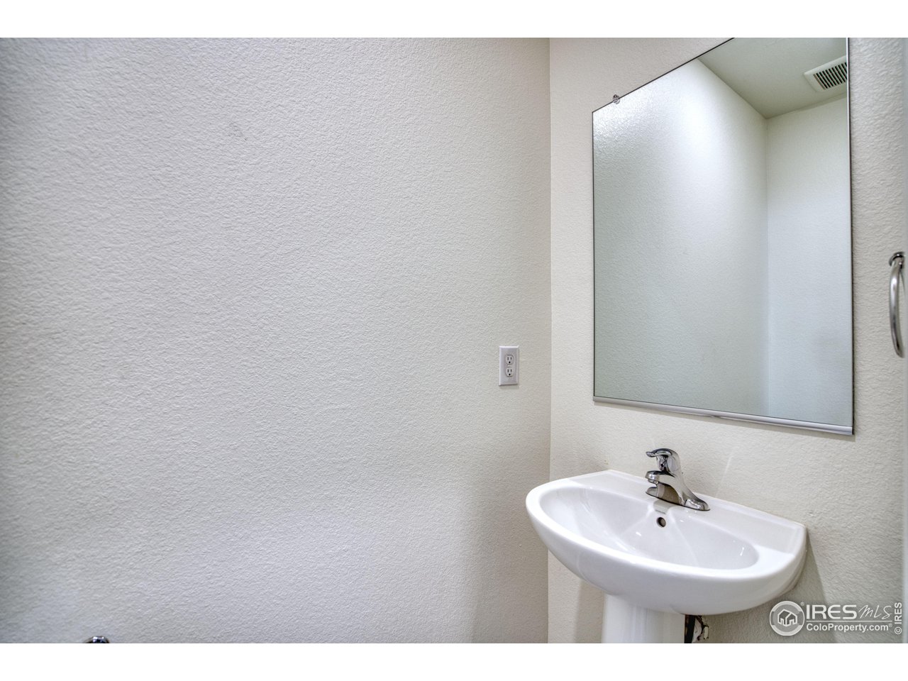 7015 Fall River Drive Frederick, CO 80530 - Photo 15 of 34 a bathroom with a sink and a mirror