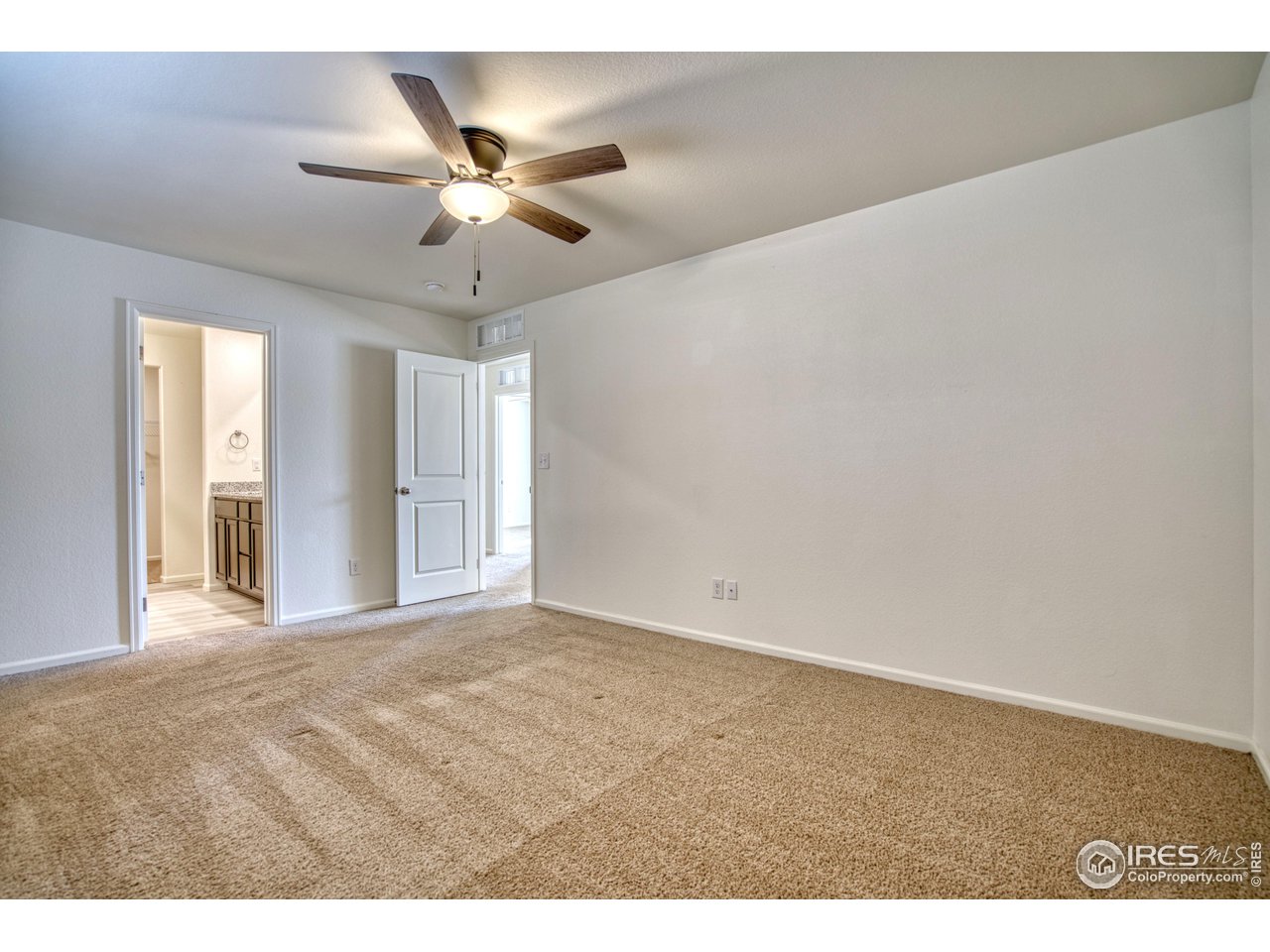 7015 Fall River Drive Frederick, CO 80530 - Photo 16 of 34 a view of an empty room with a ceiling fan