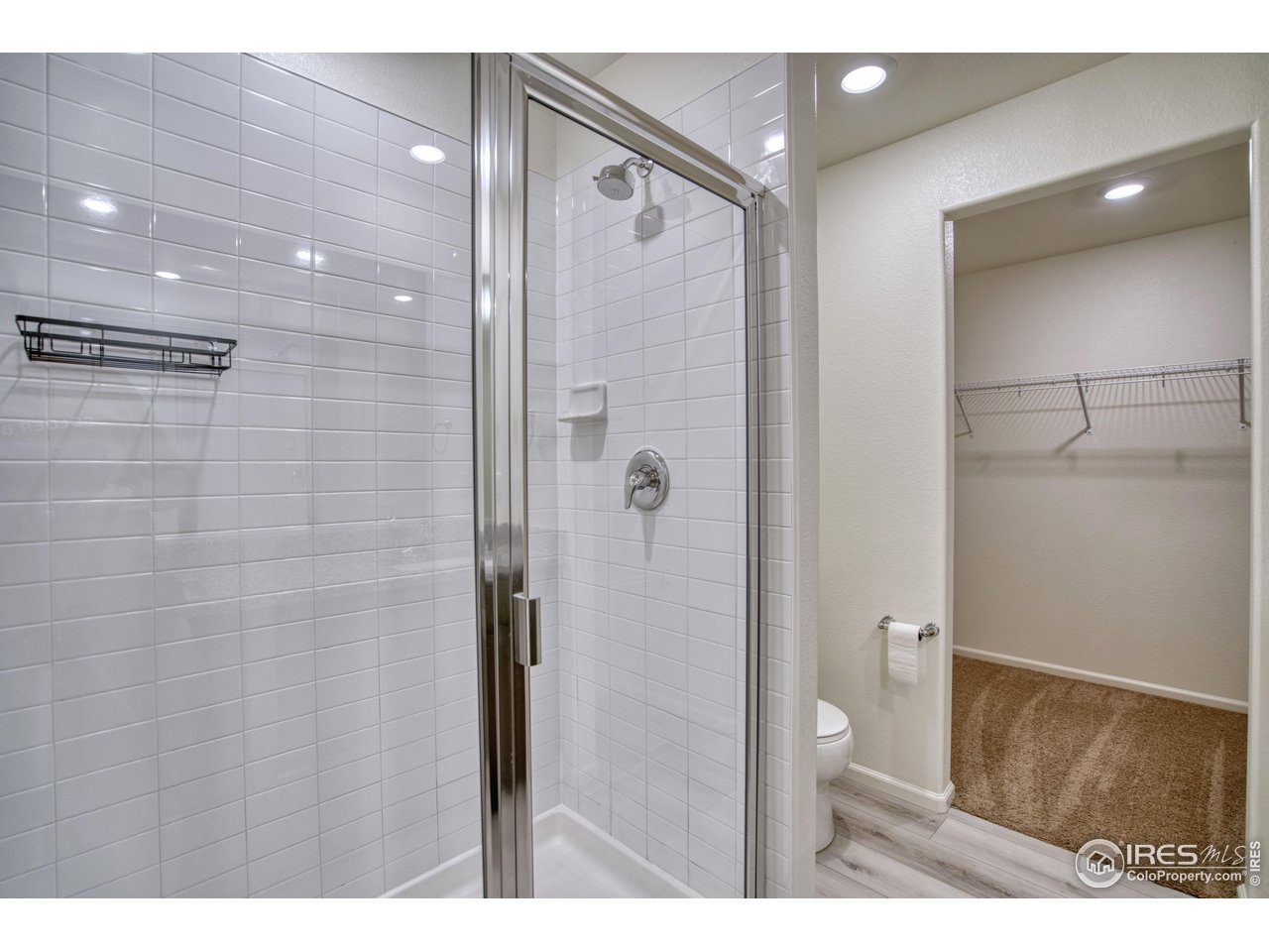 7015 Fall River Drive Frederick, CO 80530 - Photo 19 of 34 a bathroom with a shower and a glass door