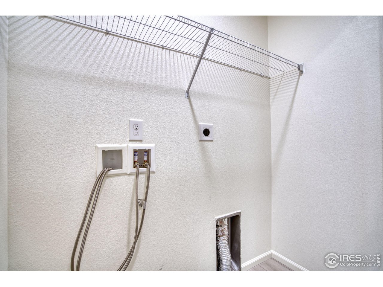 7015 Fall River Drive Frederick, CO 80530 - Photo 26 of 34 a picture of a room with wooden floor