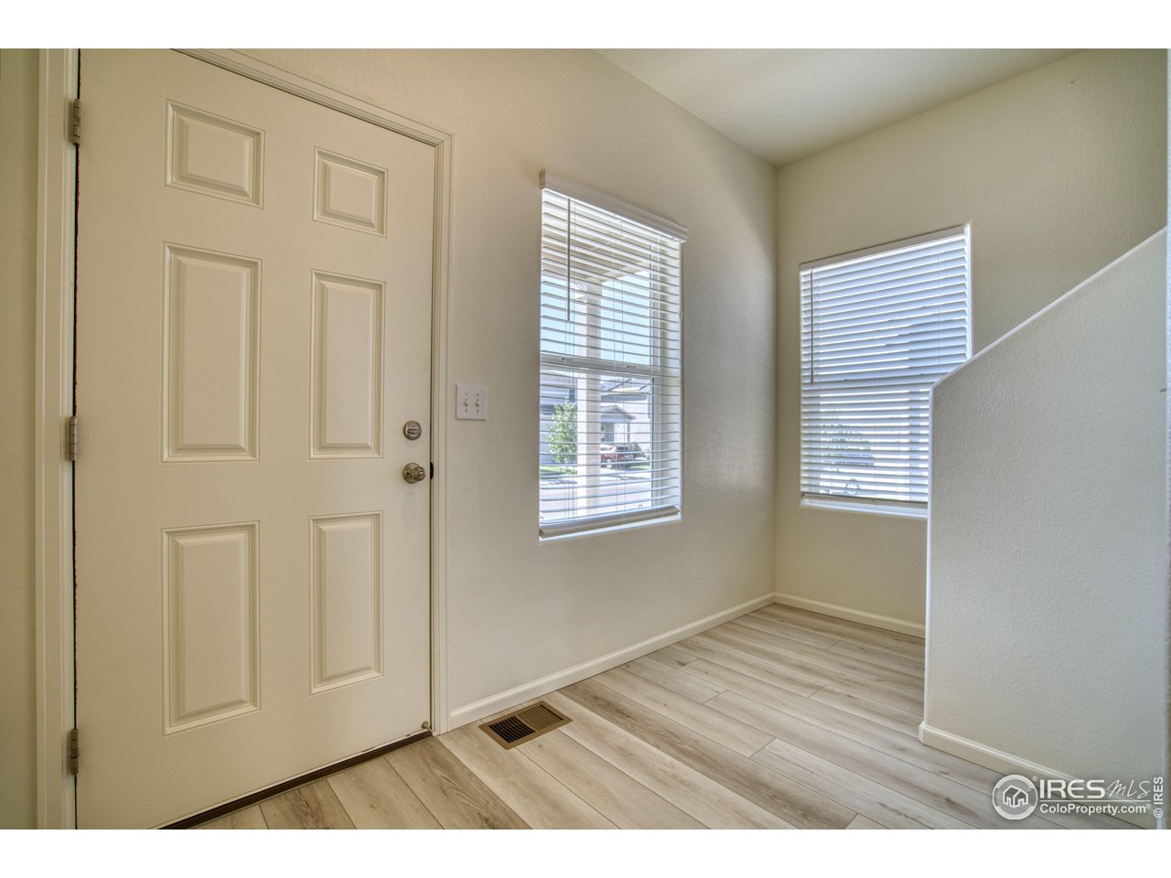 7015 Fall River Drive Frederick, CO 80530 - Photo 4 of 34 a view of an empty room with wooden floor and a window
