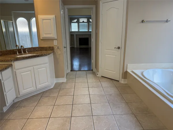 a bathroom with a granite countertop sink a mirror and a vanity