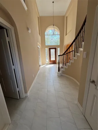 a view of entryway and hall with a front door