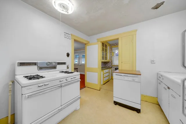 a kitchen with a stove and a white refrigerator