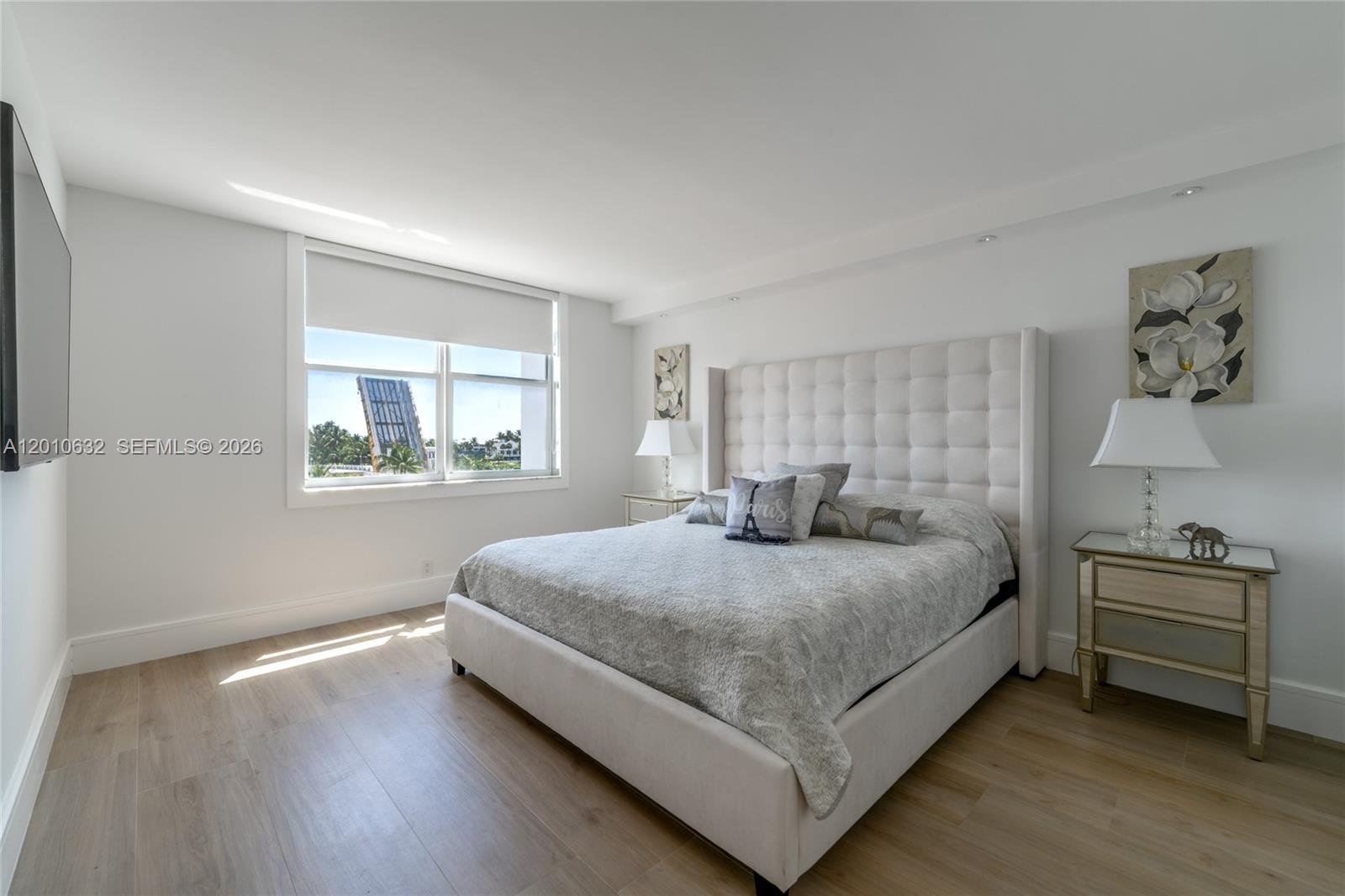 2639 North Riverside Drive, Unit 501 Pompano Beach, FL 33062 - Photo 17 of 39 a bedroom with a bed and window