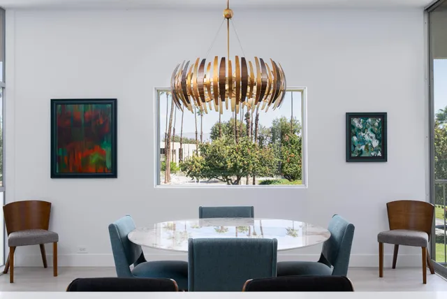 a bathroom with a sink and a painting on the wall