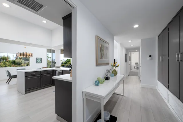 a kitchen with counter top space and wooden floor