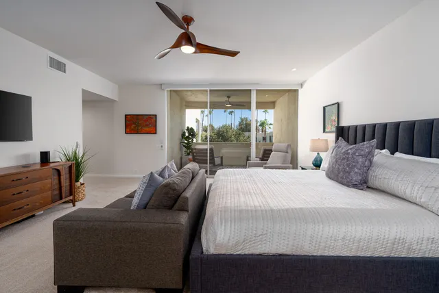 a bedroom with a bed and glass window