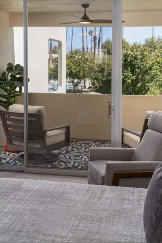 a living room with couches and a dining table with garden view