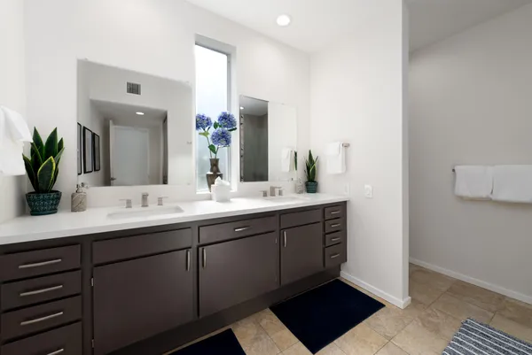 a bathroom with a double vanity sink and a mirror