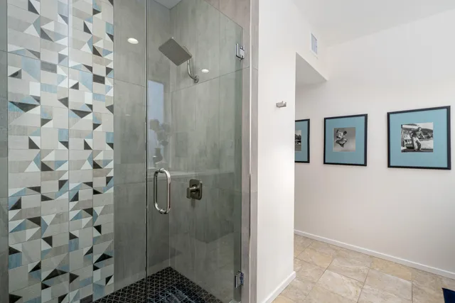 a bathroom with a shower and a sink