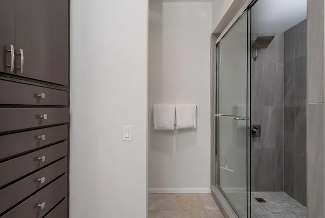 a bathroom with a shower and a glass door