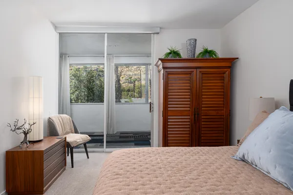 a bedroom with furniture and a window