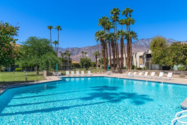 a view of swimming pool with outdoor seating and yard