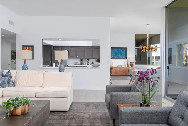 a living room with furniture and flowers