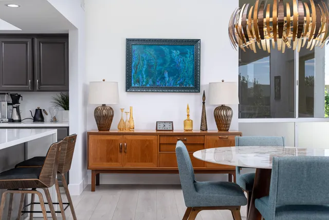 a living room with furniture a kitchen island a dining table and chairs