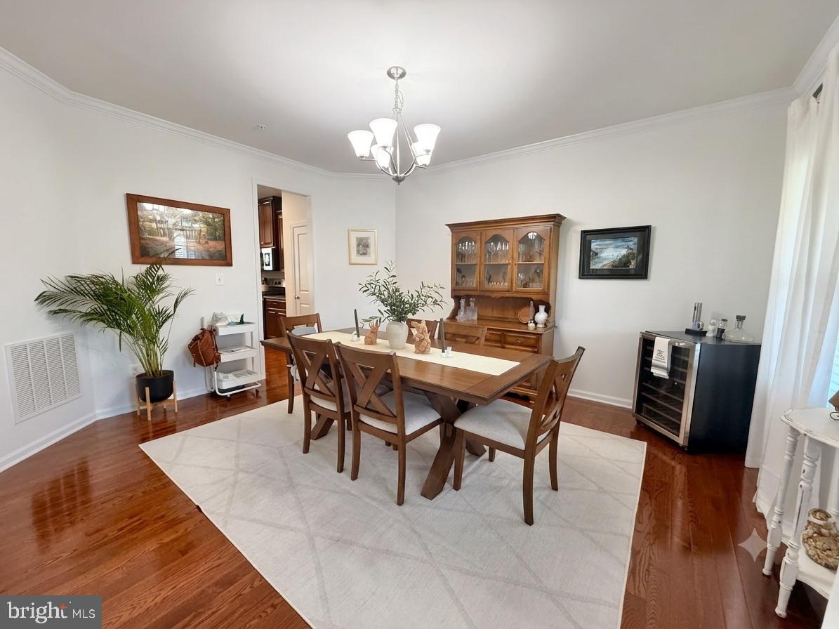 17875 Sugarberry Road Dumfries, VA 22026 - Photo 10 of 30 a view of a dining room with furniture and wooden floor