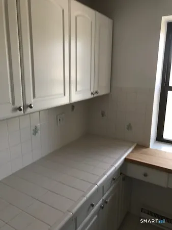 an empty room with a empty space and windows