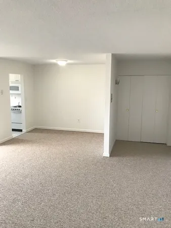 a kitchen with a sink a microwave and cabinets