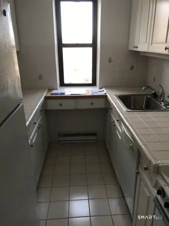 a kitchen with a sink a stove and cabinets