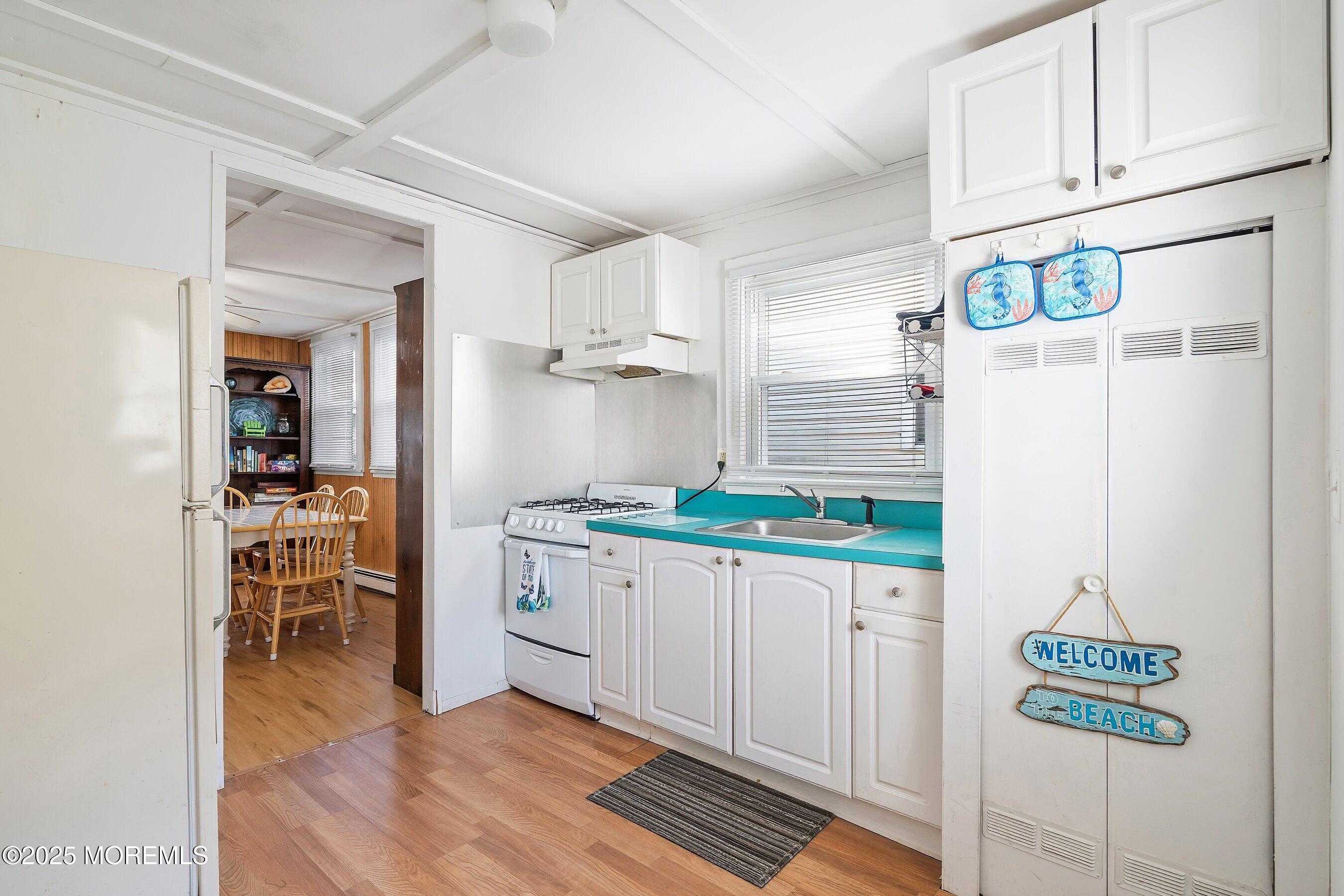 10 Brunswick Place Point Pleasant Beach, NJ 08742 - Photo 12 of 39 a kitchen with stainless steel appliances a white cabinets and a refrigerator