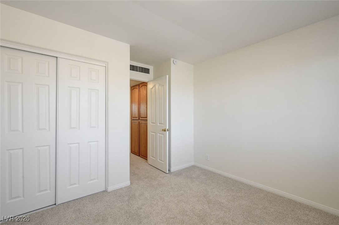 2955 El Camino Road Las Vegas, NV 89146 - Photo 73 of 99 Unfurnished bedroom with light carpet and a closet