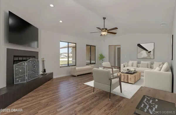 a living room with furniture a fireplace and a flat screen tv