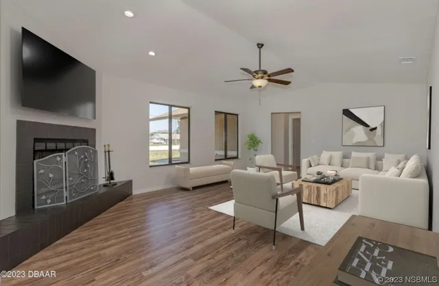 a living room with furniture a fireplace and a flat screen tv