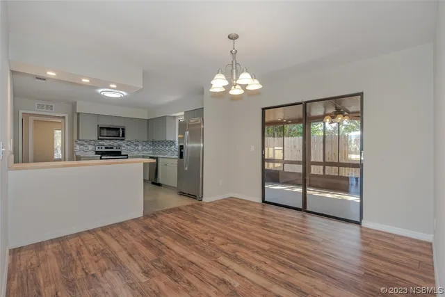 a view of a kitchen with wooden floor and a kitchen