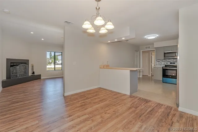 a view of a kitchen with a dishwasher cabinets and wooden floor