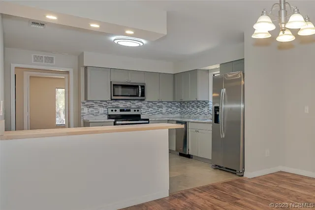 a kitchen with a refrigerator and a sink