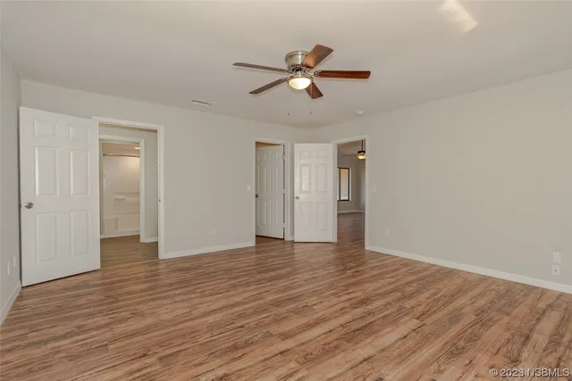 a view of an empty room and wooden floor