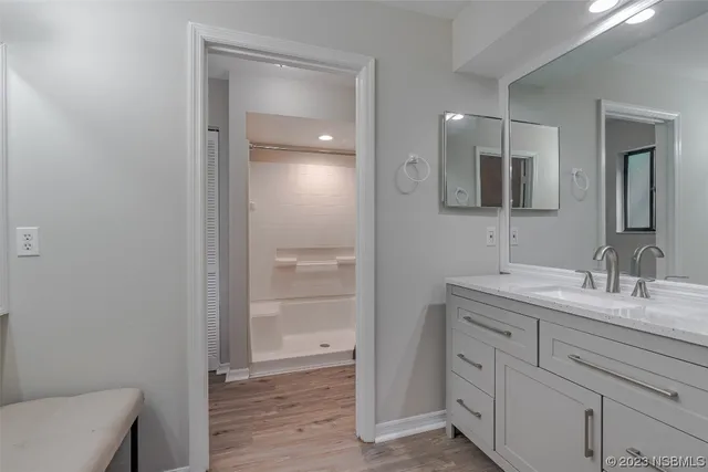 a bathroom with a granite countertop sink mirror and toilet