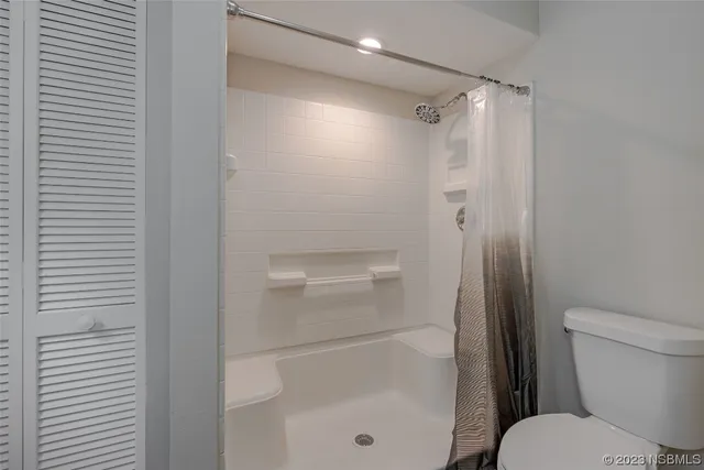 a bathroom with a shower a toilet and a sink