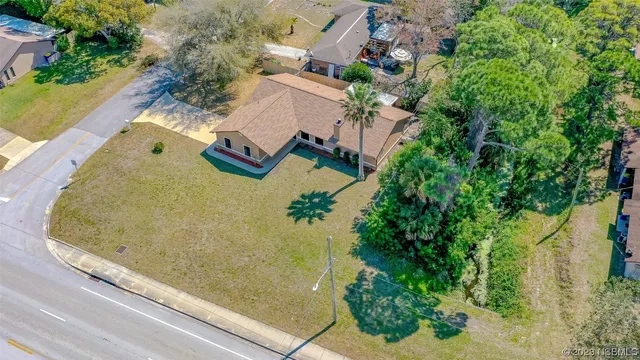 an aerial view of a house with a swimming pool