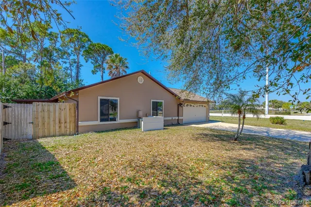 a house that has a tree in front of it