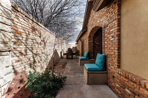 a view of patio with couches and potted plants