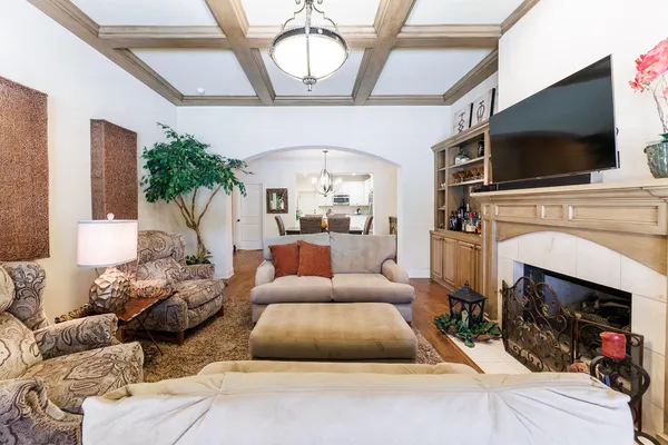 a living room with furniture a flat screen tv and a fireplace