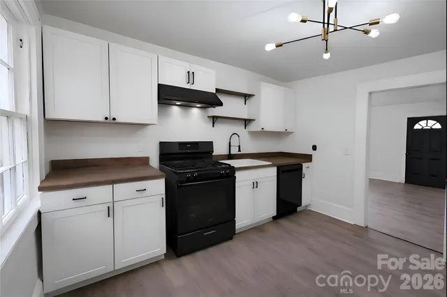 a kitchen with stainless steel appliances a sink stove and cabinets