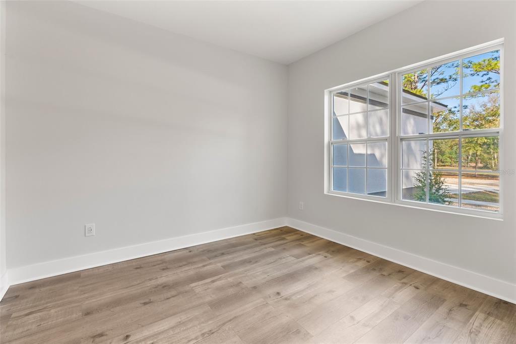 12248 Southwest 96th Lane Dunnellon, FL 34432 - Photo 13 of 26 a view of empty room with wooden floor and fan