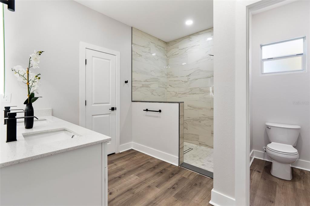 12248 Southwest 96th Lane Dunnellon, FL 34432 - Photo 21 of 26 a bathroom with a sink a toilet and shower