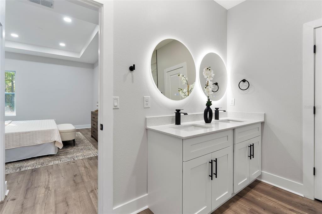 12248 Southwest 96th Lane Dunnellon, FL 34432 - Photo 22 of 26 a en suite bathroom with a double vanity sink and a mirror
