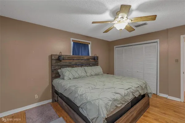 a bedroom with a bed and ceiling fan