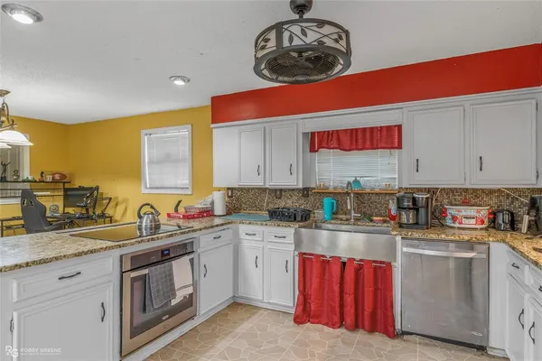 an aerial view of residential houses with outdoor space and trees