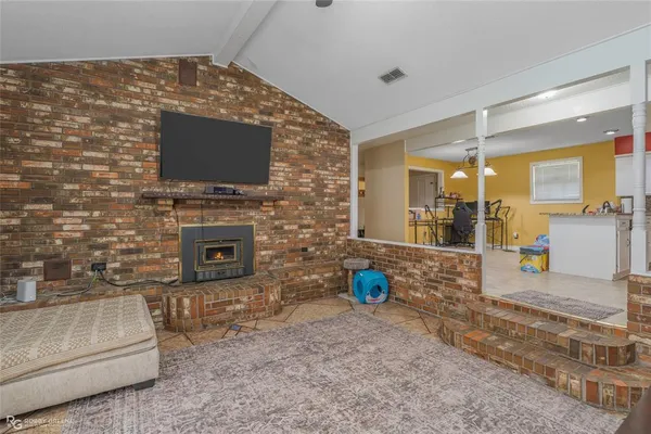a kitchen with stainless steel appliances granite countertop a refrigerator sink stove and white cabinets