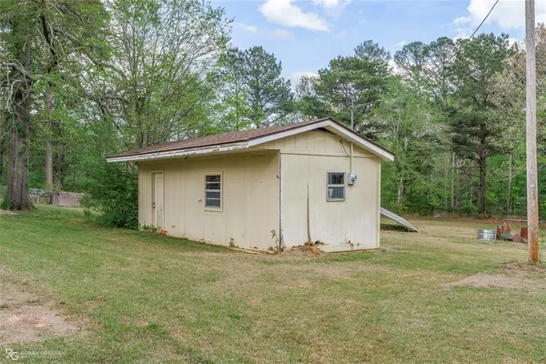 a view of a field with trees in the background